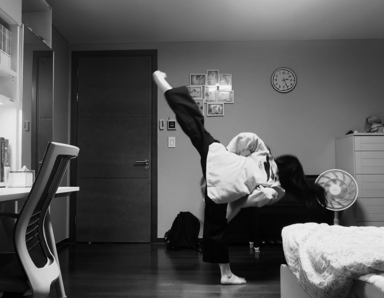 Chaeyoon practicing a high Taekwondo kick at home