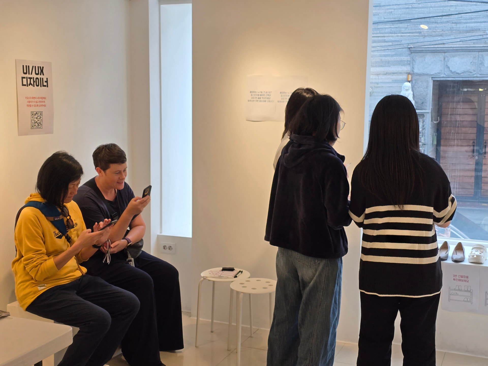 Visitors trying the PathWay app on their phones in a gallery space